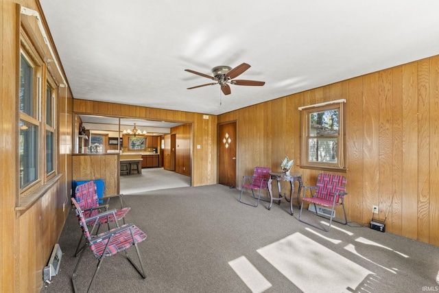 7990 S 150 E, Wolcottville, IN 46795 - living area with carpet floors, ceiling fan with notable chandelier, and wooden walls