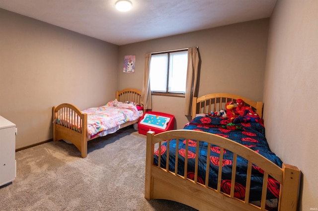 bedroom featuring baseboards and carpet floors