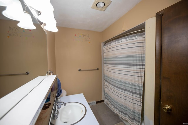 full bath with vanity and curtained shower