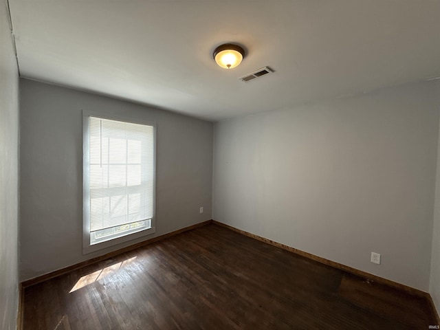 1116 Stanley Ave, Evansville, IN 47711 - spare room with dark wood-style flooring, baseboards, and visible vents