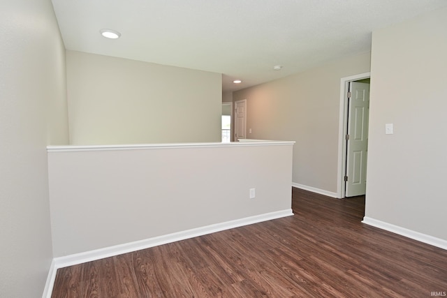 3843 S Bushmill Dr, Bloomington, IN 47403 - unfurnished room featuring dark wood-style flooring, baseboards, and recessed lighting