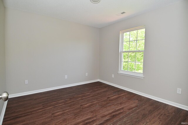 3843 S Bushmill Dr, Bloomington, IN 47403 - empty room with dark wood-style floors and baseboards