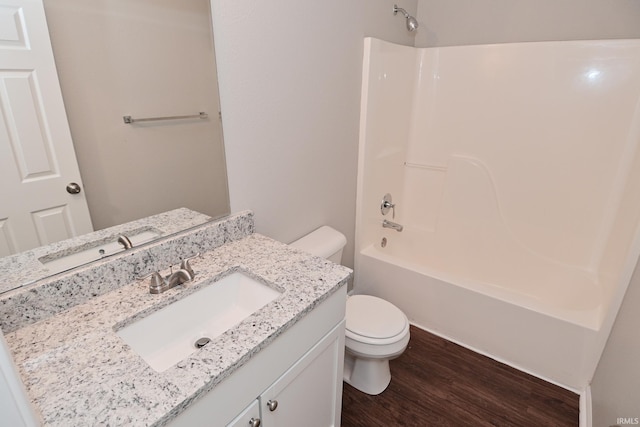 3843 S Bushmill Dr, Bloomington, IN 47403 - full bath featuring toilet, wood finished floors, vanity, and bathing tub / shower combination