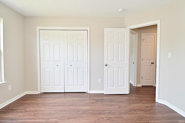 3843 S Bushmill Dr, Bloomington, IN 47403 - unfurnished bedroom with a closet, wood finished floors, and baseboards