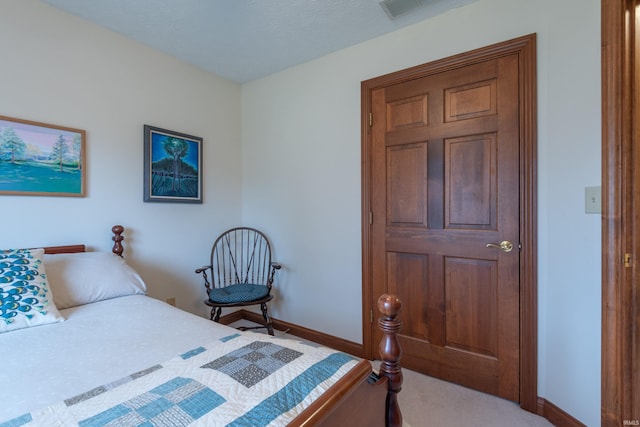 bedroom with baseboards and visible vents