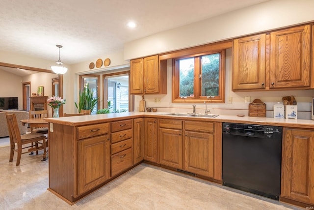 kitchen featuring a sink, brown cabinetry, and dishwasher