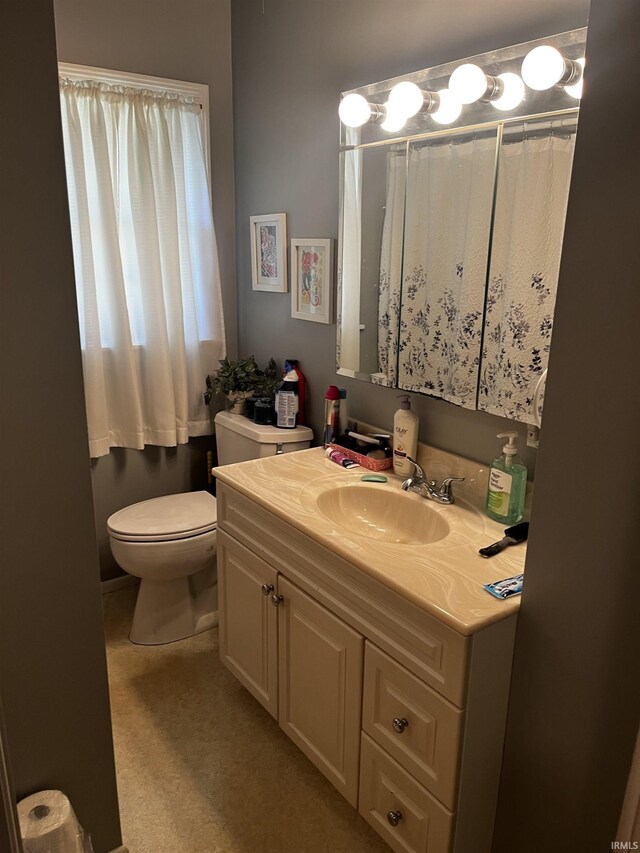 bathroom featuring toilet and vanity