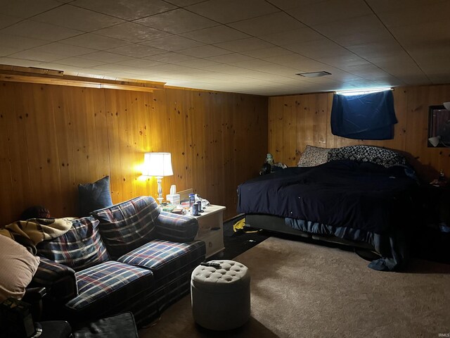 carpeted bedroom with wooden walls