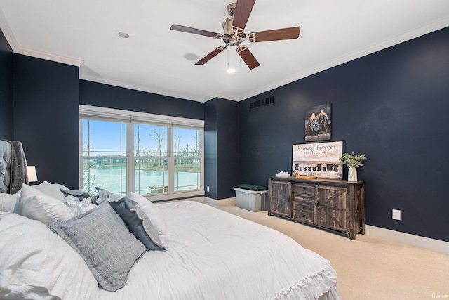 bedroom with baseboards, visible vents, crown molding, and carpet floors