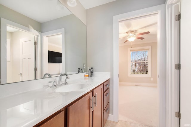 bathroom featuring baseboards, a ceiling fan, crown molding, and vanity