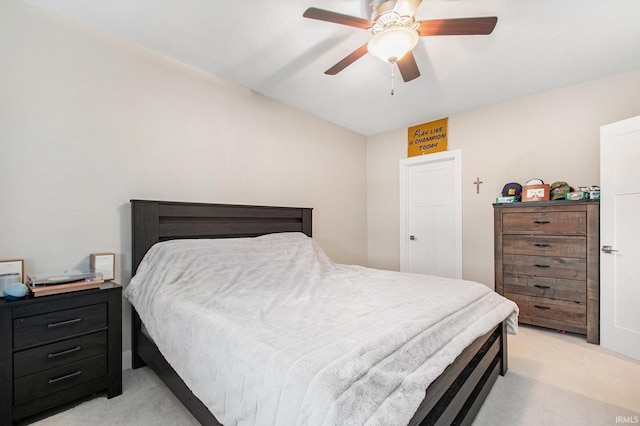bedroom featuring a ceiling fan and light colored carpet