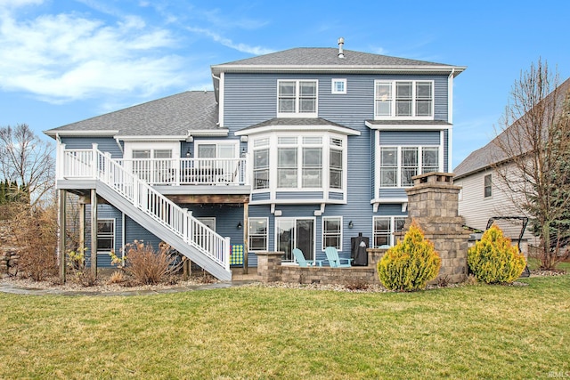 back of property featuring stairs, a shingled roof, a deck, and a yard