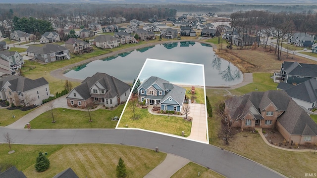 birds eye view of property with a residential view and a water view