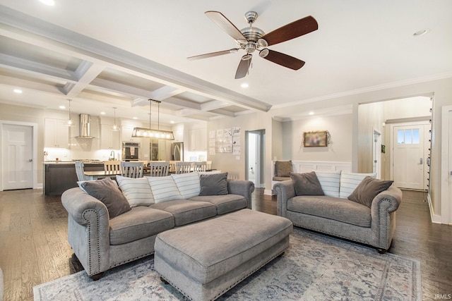 living area with wood finished floors, coffered ceiling, a ceiling fan, and beam ceiling