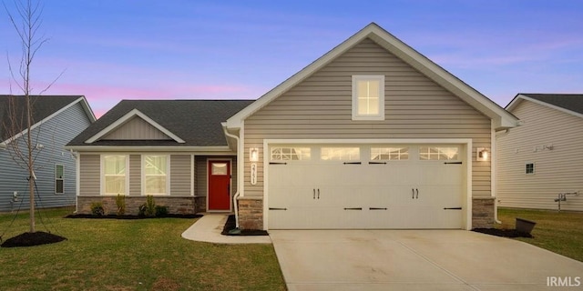 2751 Sand Hollow Dr, Lebanon, IN 46052 - view of front of house featuring stone siding, concrete driveway, a garage, and a lawn