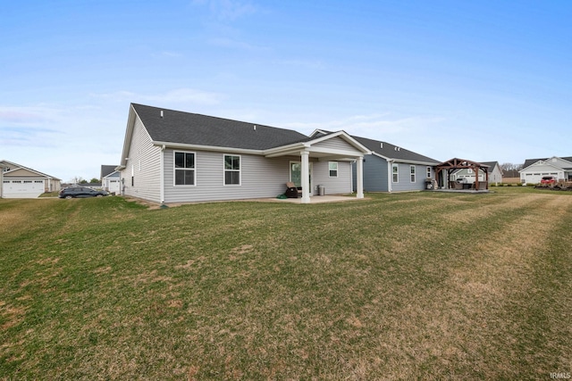 2751 Sand Hollow Dr, Lebanon, IN 46052 - rear view of property with a lawn, a patio area, and roof with shingles
