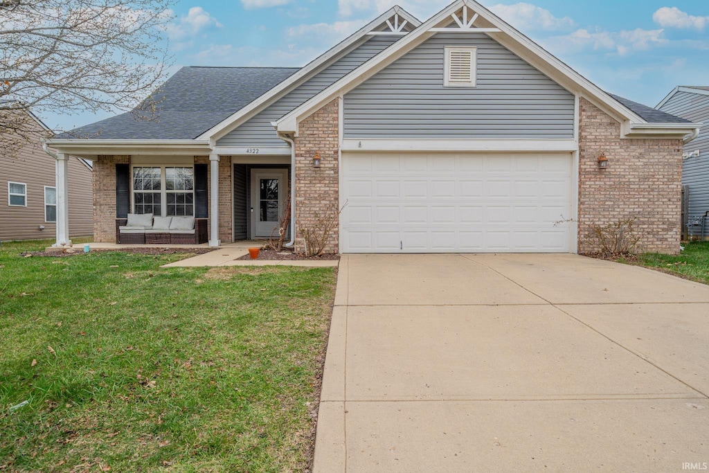 4322 Starkey Dr, Marion, IN 46953 - view of front facade featuring brick siding, driveway, an attached garage, and a front lawn