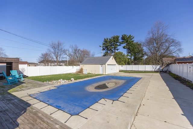 view of pool featuring a lawn, an outbuilding, and a fenced backyard
