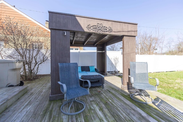 wooden terrace featuring an outdoor living space and fence