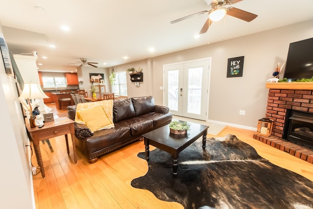 2860 E Moffett Ln, Bloomington, IN 47401 - living room featuring a brick fireplace, recessed lighting, baseboards, ceiling fan, and light wood-style flooring