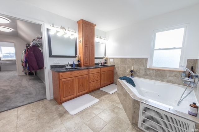 2860 E Moffett Ln, Bloomington, IN 47401 - full bathroom with a tub with jets, double vanity, visible vents, and a sink