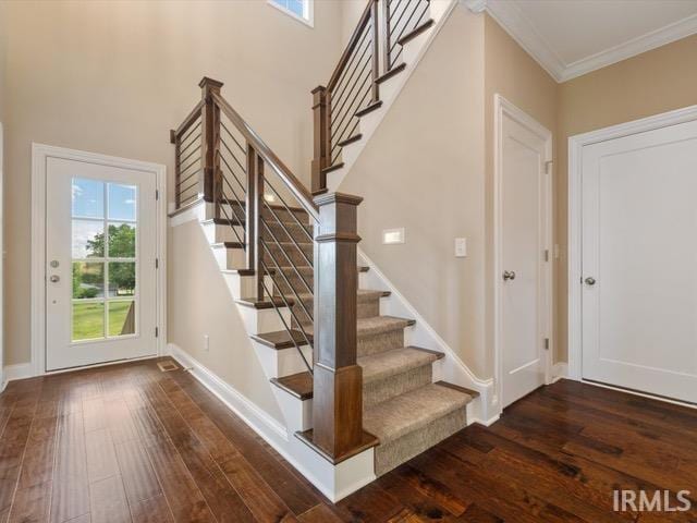 600 Whitetail Ct, Evansville, IN 47711 - stairs featuring a high ceiling, ornamental molding, baseboards, and wood finished floors