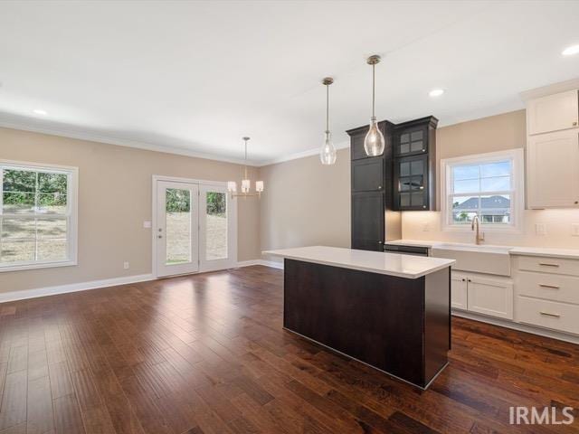 600 Whitetail Ct, Evansville, IN 47711 - kitchen featuring a center island, dark wood-type flooring, a sink, and an inviting chandelier
