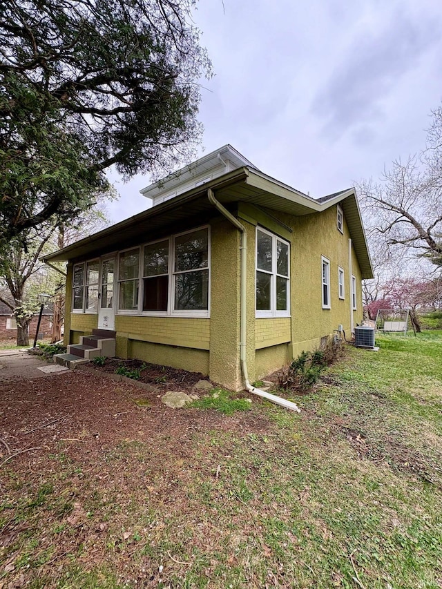 1951 Indian Mounds Blvd, Evansville, IN 47715 - view of property exterior featuring central air condition unit, entry steps, and stucco siding