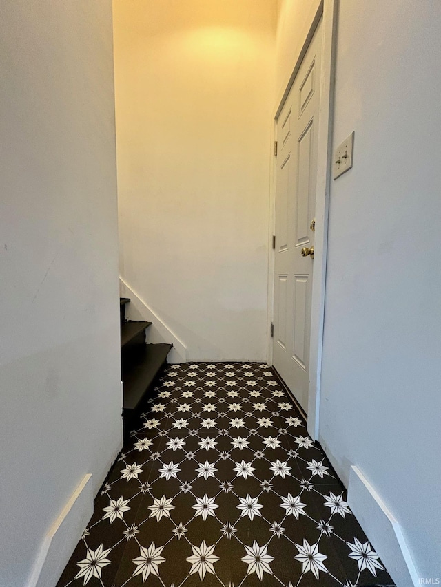 1951 Indian Mounds Blvd, Evansville, IN 47715 - corridor featuring tile patterned floors, baseboards, and stairway