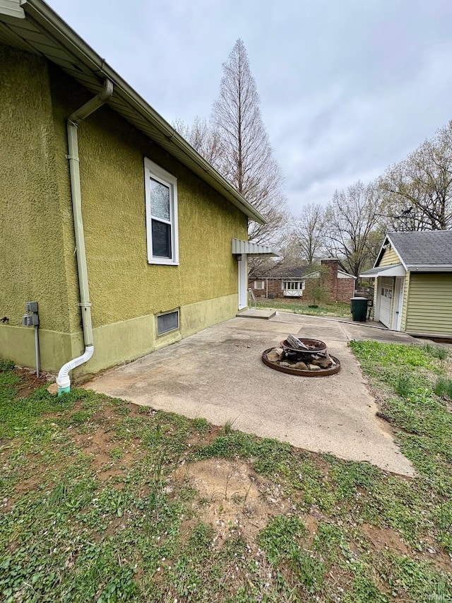 1951 Indian Mounds Blvd, Evansville, IN 47715 - view of patio / terrace with an outbuilding, a fire pit, and a garage