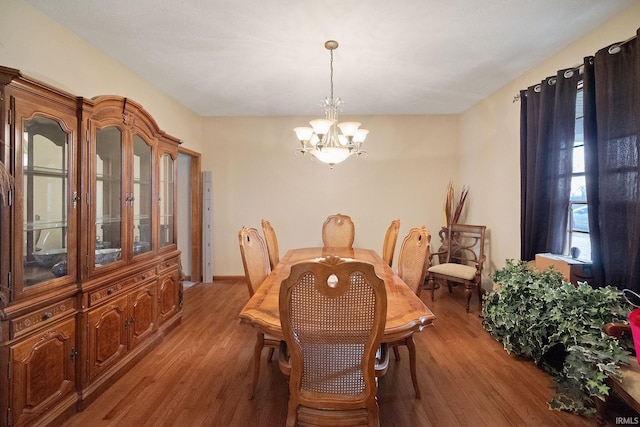 4277 S 100 W, Williamsport, IN 47993 - dining space featuring light wood-type flooring and an inviting chandelier