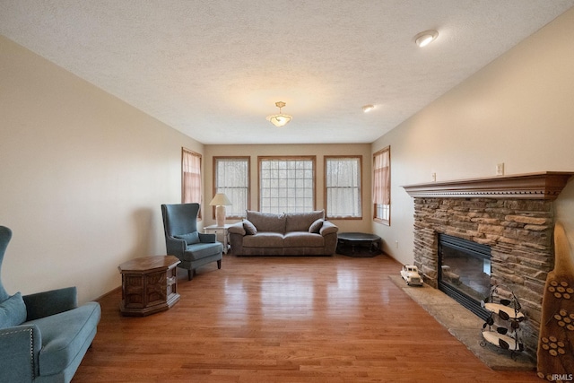 4277 S 100 W, Williamsport, IN 47993 - living room with light wood-style floors, a fireplace, and a textured ceiling