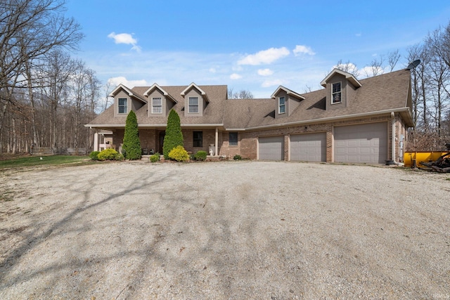 4277 S 100 W, Williamsport, IN 47993 - new england style home featuring a shingled roof, dirt driveway, brick siding, and a garage