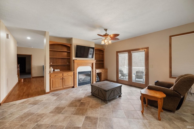 4277 S 100 W, Williamsport, IN 47993 - living area featuring a ceiling fan, a glass covered fireplace, baseboards, and a textured ceiling