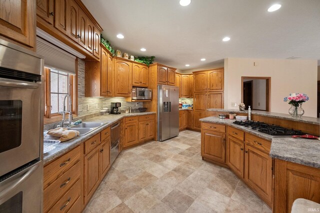 4277 S 100 W, Williamsport, IN 47993 - kitchen featuring a sink, appliances with stainless steel finishes, recessed lighting, and brown cabinets