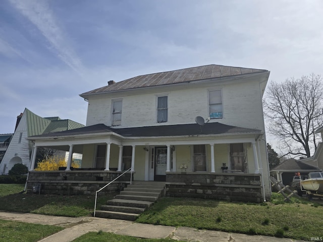 view of front of house featuring a standing seam roof, metal roof, and a porch