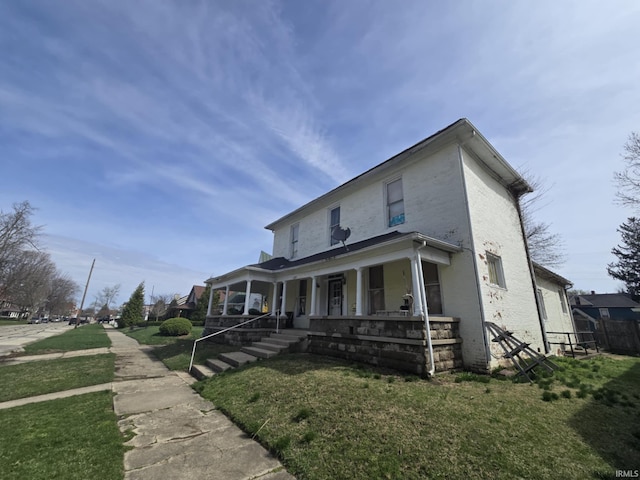 view of front of house featuring a front yard, covered porch, and fence