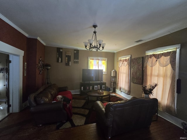living room featuring crown molding, baseboards, visible vents, a notable chandelier, and wood finished floors