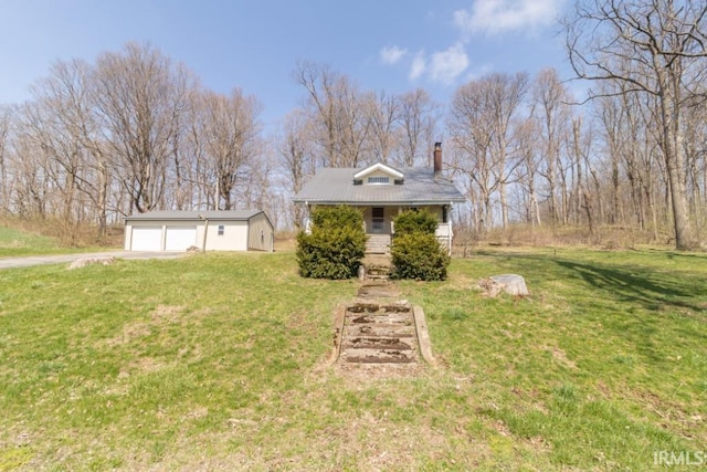 2645 S Greensboro Pike, New Castle, IN 47362 - view of front of home with a chimney, a front yard, an outdoor structure, and a garage