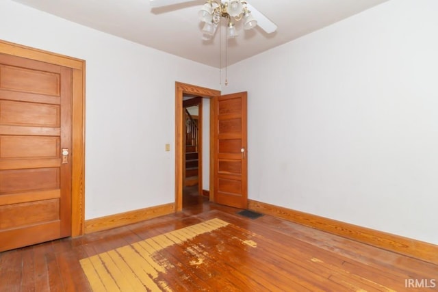 2645 S Greensboro Pike, New Castle, IN 47362 - spare room featuring baseboards, visible vents, ceiling fan, and hardwood / wood-style flooring