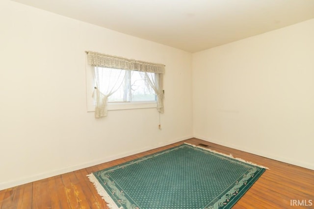2645 S Greensboro Pike, New Castle, IN 47362 - empty room with hardwood / wood-style flooring, baseboards, and visible vents