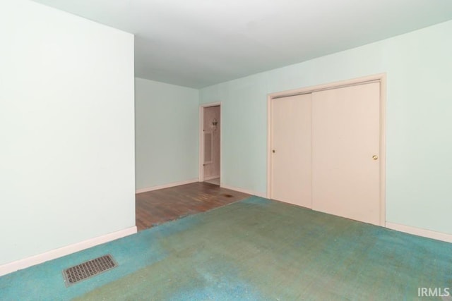 2645 S Greensboro Pike, New Castle, IN 47362 - unfurnished bedroom featuring baseboards, visible vents, a closet, and carpet flooring