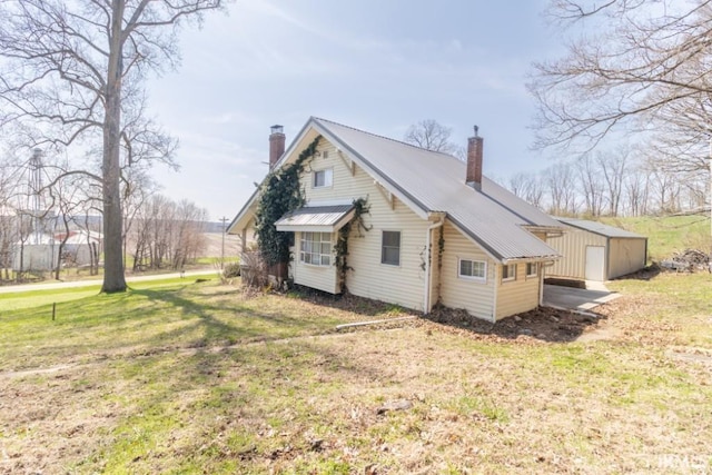 2645 S Greensboro Pike, New Castle, IN 47362 - exterior space with a lawn, a chimney, and metal roof