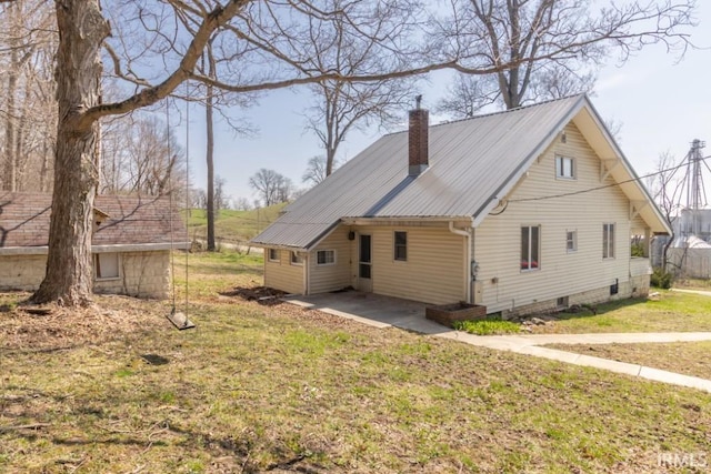 2645 S Greensboro Pike, New Castle, IN 47362 - rear view of house with a lawn, metal roof, and a chimney