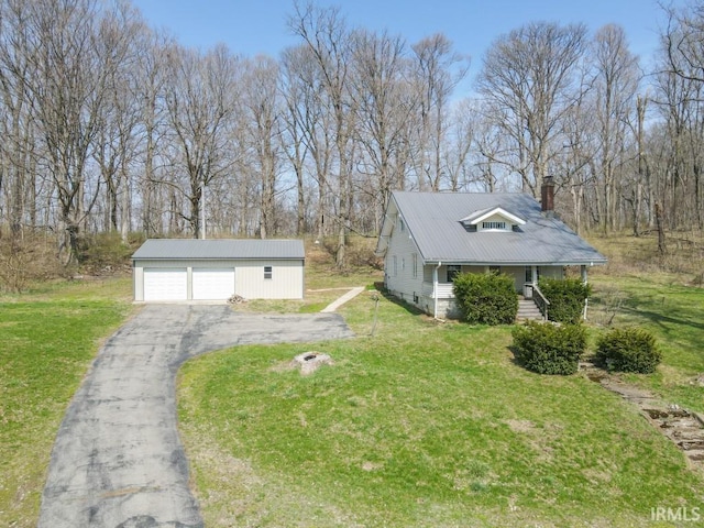 2645 S Greensboro Pike, New Castle, IN 47362 - view of front of property featuring metal roof, a chimney, a garage, a front yard, and an outbuilding
