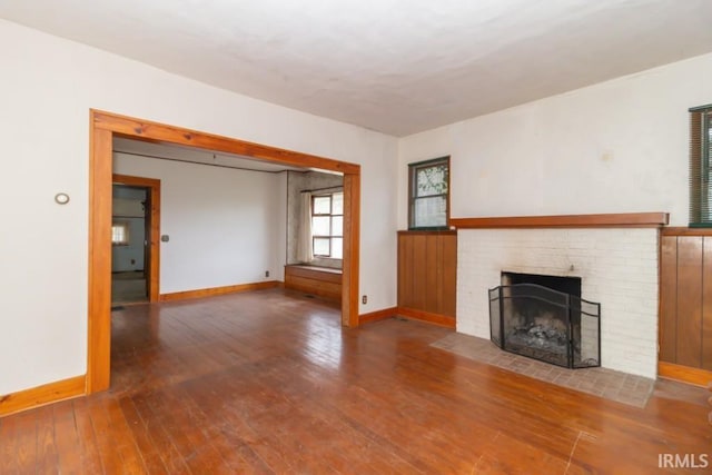 2645 S Greensboro Pike, New Castle, IN 47362 - unfurnished living room featuring hardwood / wood-style floors, baseboards, and a fireplace