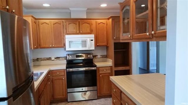905 Stewart Ave, Evansville, IN 47715 - kitchen with stainless steel appliances, crown molding, glass insert cabinets, light countertops, and brown cabinetry