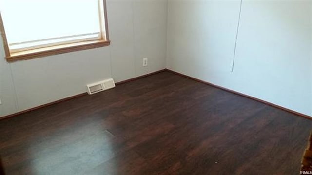 905 Stewart Ave, Evansville, IN 47715 - empty room featuring dark wood-type flooring and baseboards