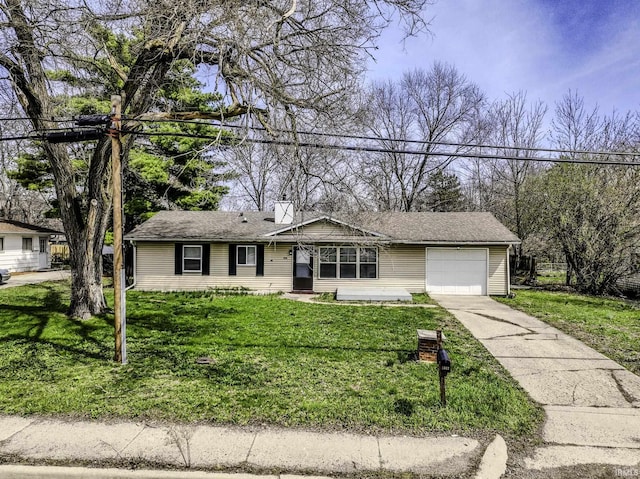 ranch-style house featuring a front lawn, driveway, and an attached garage