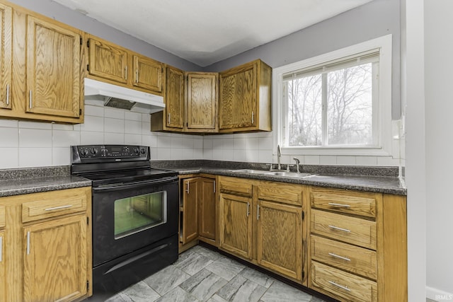 kitchen with a sink, under cabinet range hood, dark countertops, electric range, and decorative backsplash